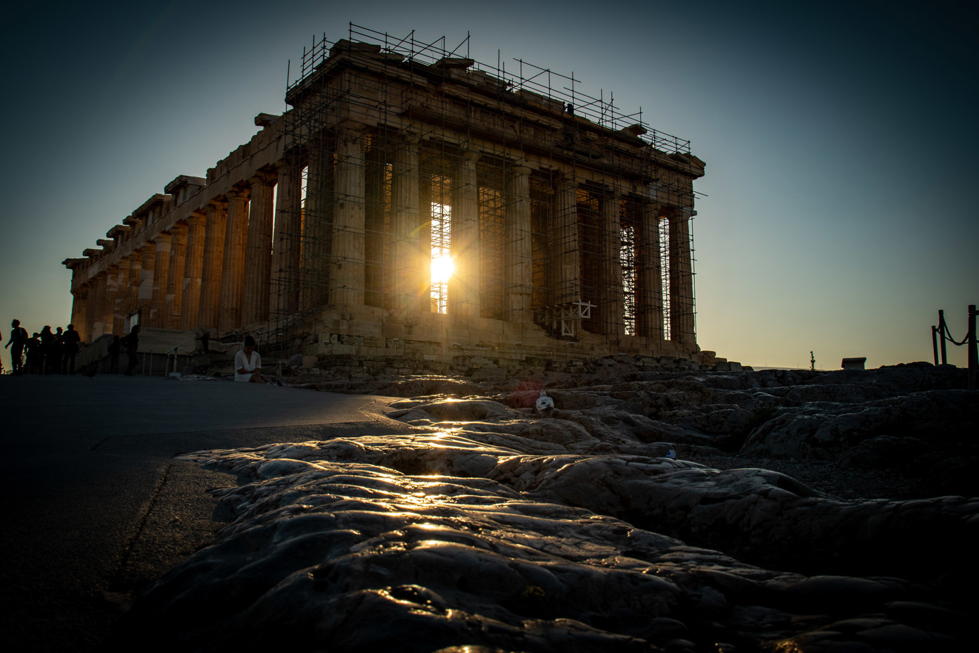 Sunlight floods the Parthenon columns on the Acropolis in the morning and reflects off the rocks.