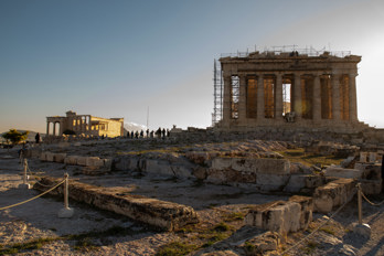 Early morning on the Akropolis with few tourists. The Parthenon on the right and the temple of Erechtheion on the left.