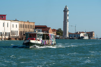 Actv boat in front of Murano Lighthouse