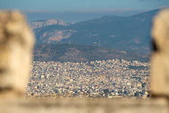 Athens through the wall of the Acropolis. Taken with a long focal length lens.