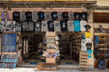 An open Sovenian shop with T-shirts, handbags, postcards and other typical items.