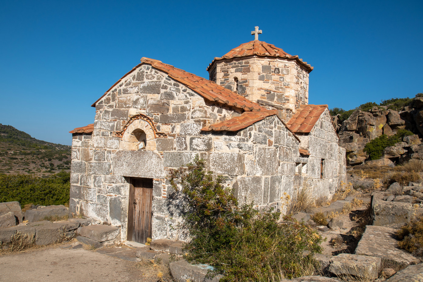 The Byzantine church of Taxiarches was built over the ruins of the Temple of Zeus Hellanius on Mount Hellanion Oros on the island of Aegina in the 12th century. It is located on a hiking trail that leads from the car park below Mount Hellanion Oros to the summit.