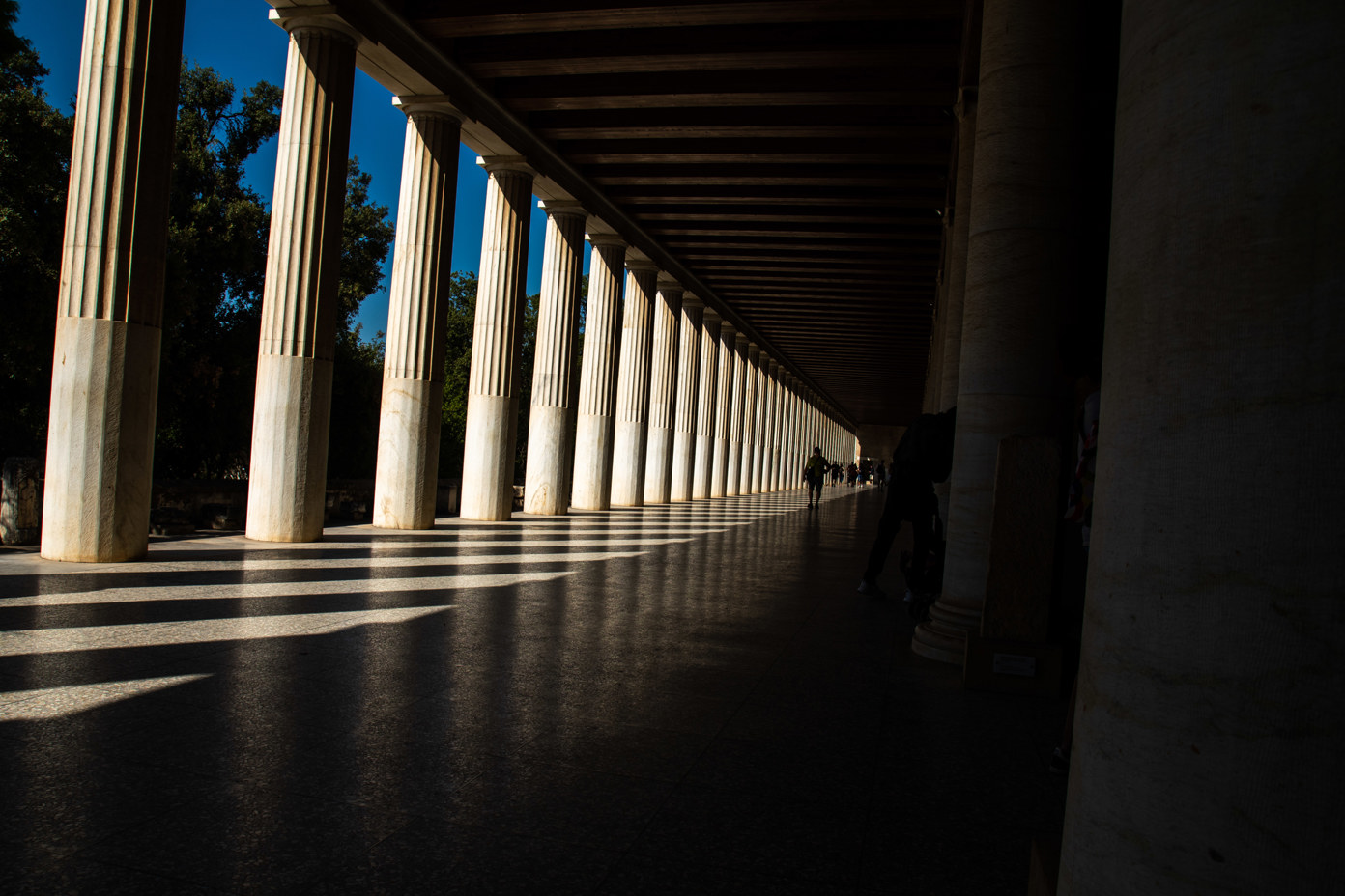 The afternoon sun illuminates only the columns, leaving the reconstructed Hellenistic portico on the Athenian Agora in the shade.