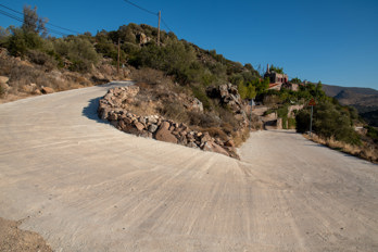 The hiking trail between the beach of Marathonas and Pachia Rachi on the island of Aegina, the otherwise unpaved path is paved here over a length of approx. 200 m.