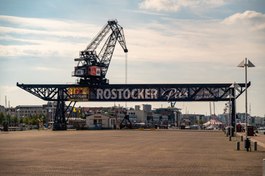 Histroric cargo crane in the Rostock city harbor in the Warnow Bay.