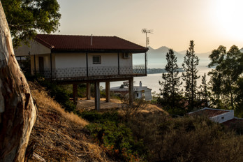 A stilt house in the settlement of Aiginitissa on the island of Aegina. The Saronic Gulf and the town of Perdika in the background.