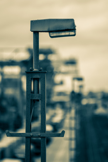 Street lamp in industrial area marked by rust    