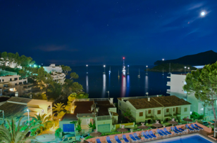 Long time shot at night on the sea with illuminated boats from a hotel in Sant Elm.  