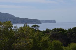 View from the uninhabited rocky island over the Canal des Fre to the cliffs of Mallorca