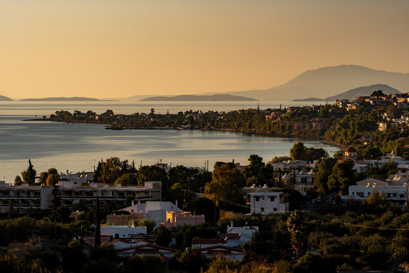 The bay of Marathonas at sunset, in the west of the island of Aegina, from the footpath that leads directly into the valley of Eleonas. On the right side of the bay is the beach of Paralia Agios Vasilios.