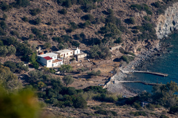 View from the highest mountain in Aegina, Hellanion Oros, to the church of Panagia of Blachaernae in the south of the island on the beach of Kípoi. The photo was taken with a telephoto lens.