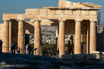 The first tourists marvel in the morning sun at the Propylaeum, the gate and main entrance to the Acropolis