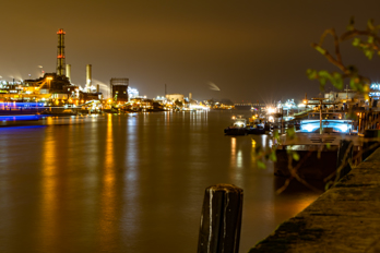 Rhine with chemical plant and quay at night