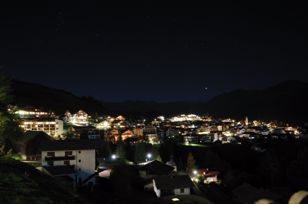 Village center of Serfaus at night with starry sky 