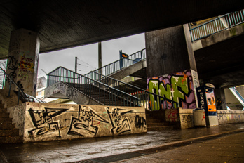 Neglected place under the bridge with stairs to the light