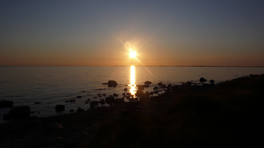 Sun goes down on a stony beach