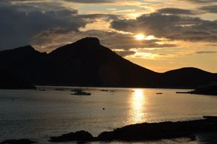 Evening atmosphere at the sea. Backlight shot with high contrast. Contours of the island Sa Dragonera.
