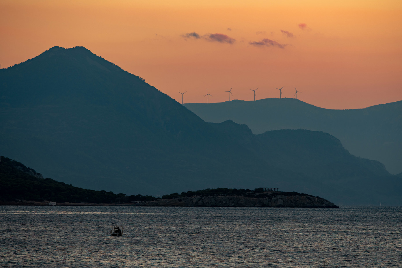 Sunset with wind turbines at Marathonas Beach