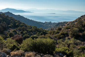 View from the valley of Eleonas, an uninhabited plateau on the island of Aegina, west through a valley to the beach of Marathonas, in the background the Saronic Gulf with the island of Agkistri and very small the uninhabited island of Metopi.