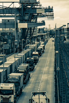 Long road with trucks waiting for clearance with gantry crane 