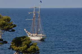 A sailing ship is anchored off the coast of Sant Elm, Mallorca